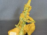 figurine of a man riding a horse with a bird on its back