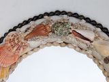 a mirror with shells and seashells on it