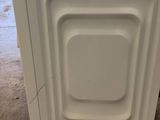 an image of a white dishwasher sitting on top of a counter