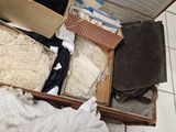 a box full of clothes and other items sitting on the floor