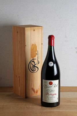 a bottle of wine sitting next to a wooden box