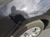 the shadow of a person on a skateboard on the side of a car