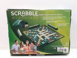 a scrabble board game in the box on the table
