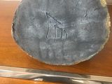 a giraffe carved into the side of a piece of wood