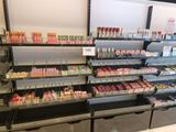 many different shades of lipstick on the shelves in the store