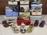 many pairs of shoes sitting on a table with boxes