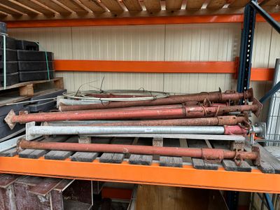 a lot of pipes that are stacked on a shelf