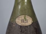 a green bottle with a brown label on it