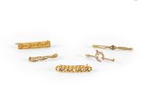 a set of five gold hair clips with diamonds on them