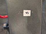 a black and red gym chair in the middle of a gym