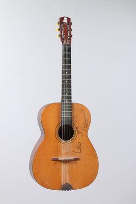 a close up of an acoustic guitar on a white background