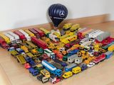a lot of toy trucks and a hot air balloon on the floor