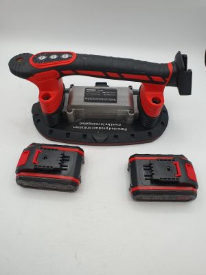 a close up of a cordless drill and two batteries