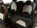 two seats in the back of a car that are black and white