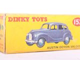 a box of dinky toys sitting on a white surface
