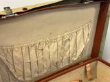 an open suitcase with a piece of cloth inside of it