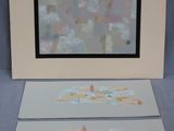 two paintings that are on the table next to each other