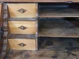 a wooden desk with three drawers on top of it