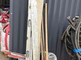 a pile of skis and ski poles in front of a building