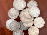 some silver coins are sitting on a wooden table