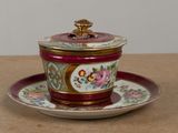 a small cup and saucer on a saucer on a table