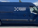 a blue van that is parked in a parking lot