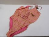 a pink bikini with a tag on it laying on a table