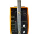 an orange and black radio sitting on top of a white surface