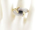 an image of a ring with a sapphire and diamonds on it