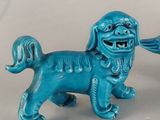 two figurines of a dog and a bird on a table