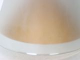 a close up of a bowl of liquid on a table