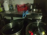 pots and pans are sitting on a table in a kitchen