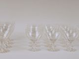 six clear wine glasses sitting on top of a white table