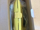 a yellow computer mouse in a box on a table