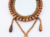 wooden beaded mirror with tassels and tassels hanging from it