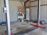 a garage with two jacks in the middle of it