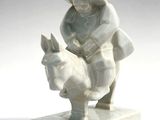 a statue of a man riding a donkey with a hat on