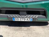 a close up of the front of a green mercedes truck