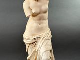 statue of a woman holding a vase in her right hand