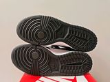 the soles of a pair of black and white shoes on top of a red and white box
