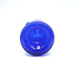 a blue glass bottle with a blue lid sitting on a white surface