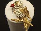 a small white box with a gold bird on it