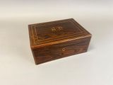an old wooden box sitting on top of a white surface