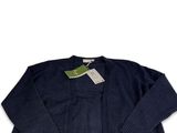 a blue sweater with a tag on the back of it