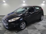 the black ford fiesta is parked on a checkered tile floor