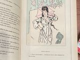 an open book with a drawing of a woman holding an umbrella