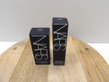 two boxes of nars cosmetics on a wooden table