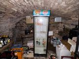 a refrigerator in the middle of a room filled with bottles of beer