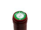 a bottle of wine that has a green label on it