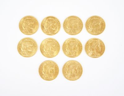 several gold coins arranged in the shape of a heart on a white surface